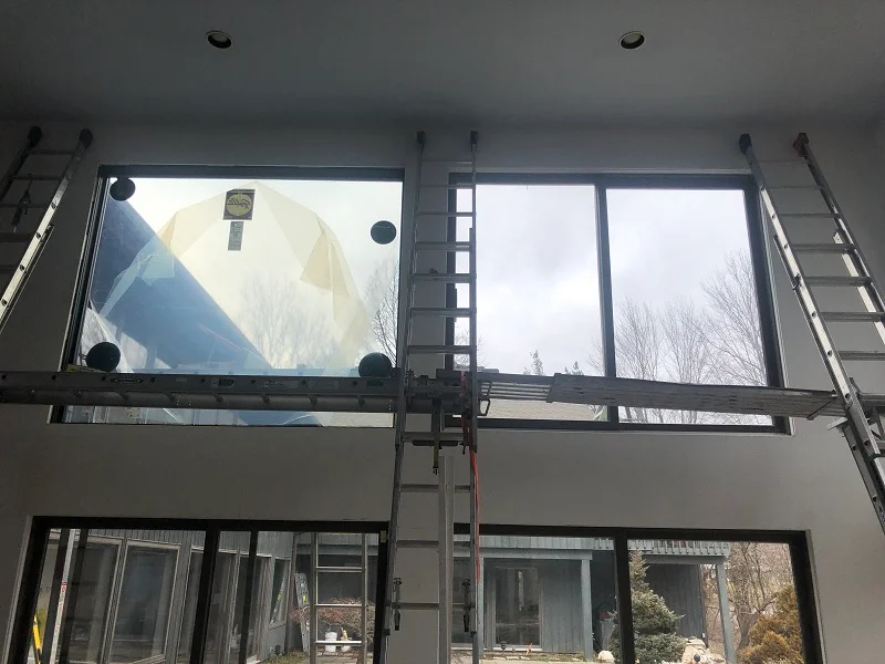 Suction cups are used to lift these Pella picture windows